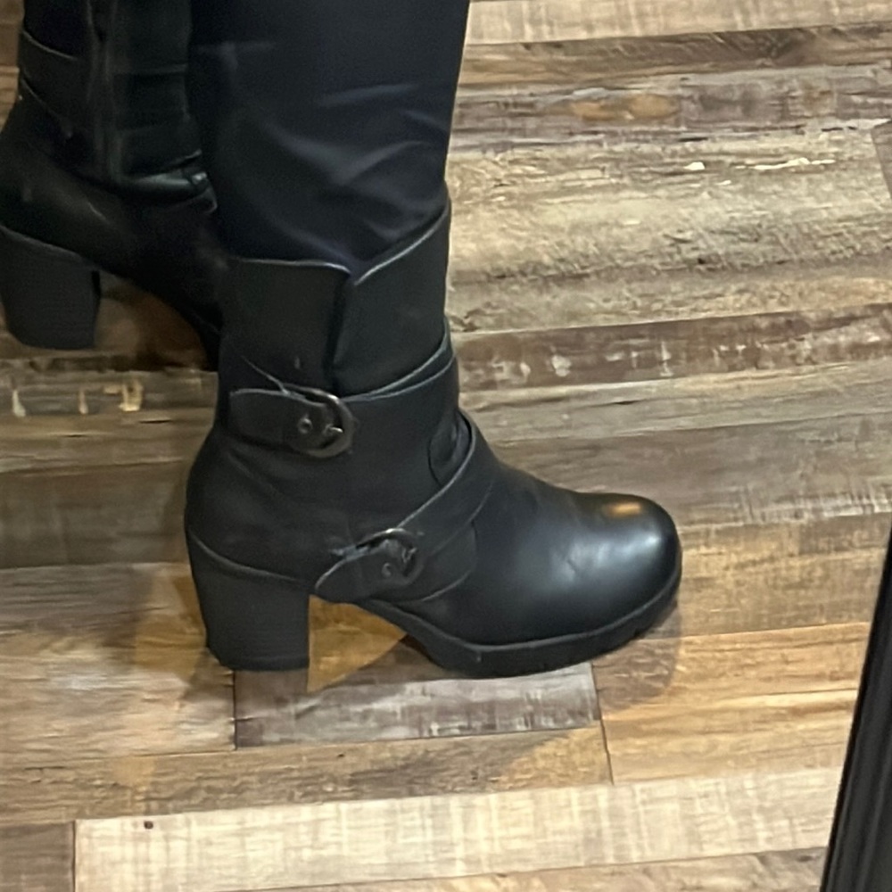 Black leather calf high boot. With adorable belt detail.